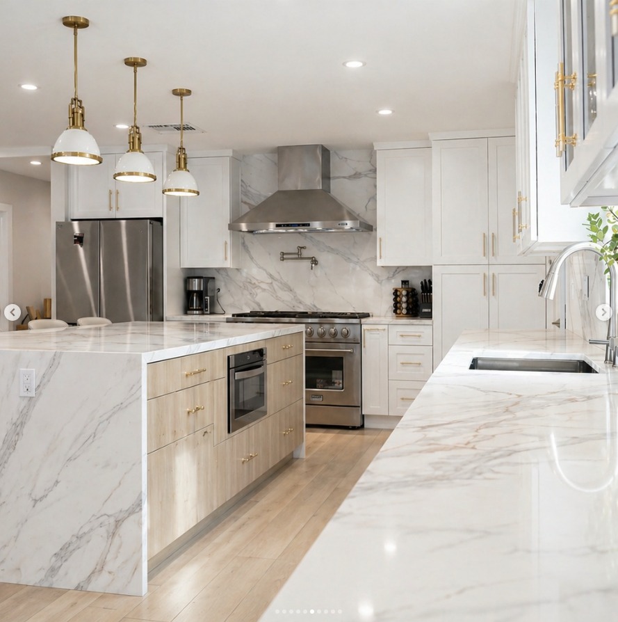 Woodland Hills kitchen after — marble waterfall island, professional range and statement hood