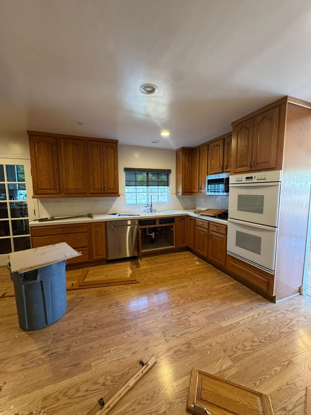 Woodland Hills kitchen before remodel — dated oak cabinets, tile counters and closed galley layout