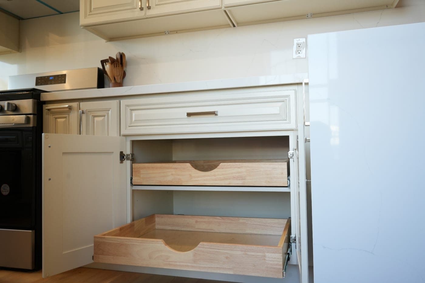 Base cabinet open to show two soft-close pull-out drawers with dovetailed boxes