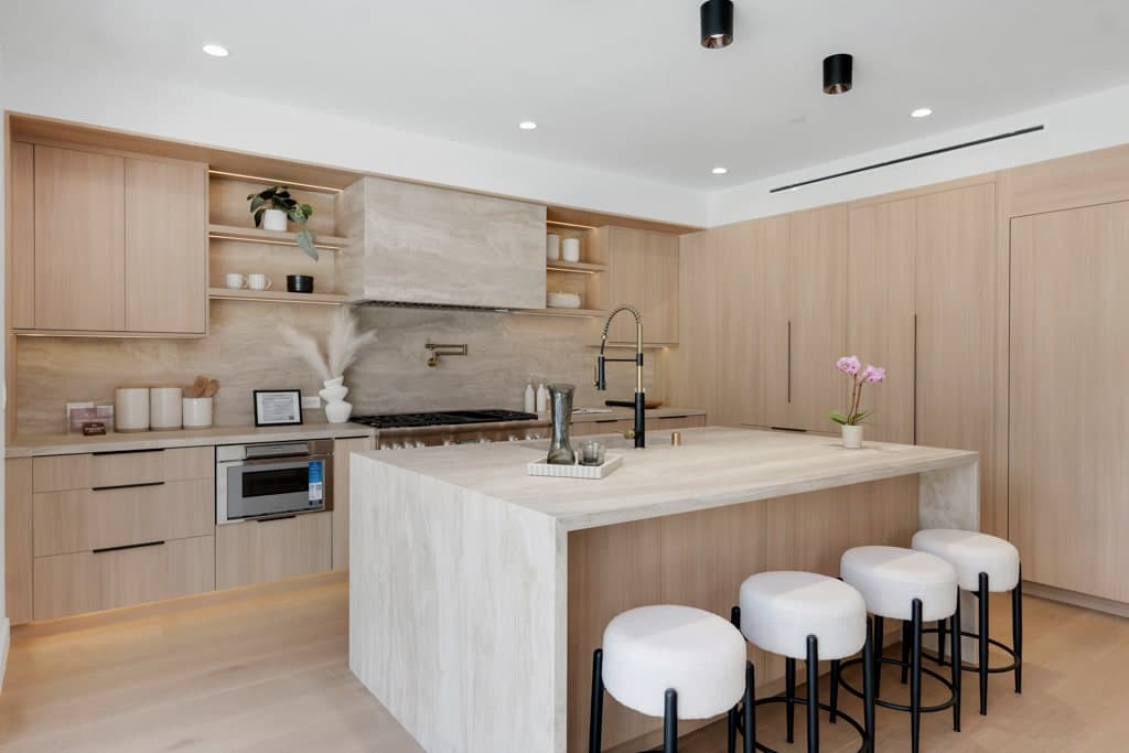 Island, professional range and stone-clad hood with LED-lit oak shelving