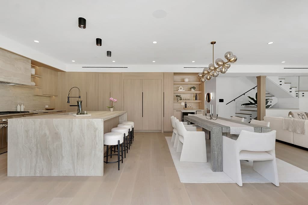 Full kitchen remodel in West Hollywood with light oak cabinetry and a stone waterfall island
